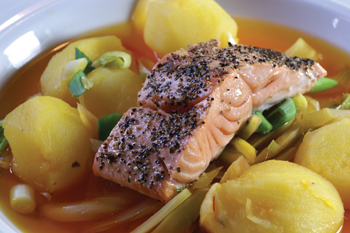 Peppered salmon with saffron potatoes and spiced broth